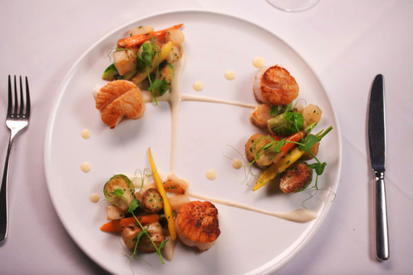 Scallops with artichokes, romanesco, brussels, and fingerlings from Aria 