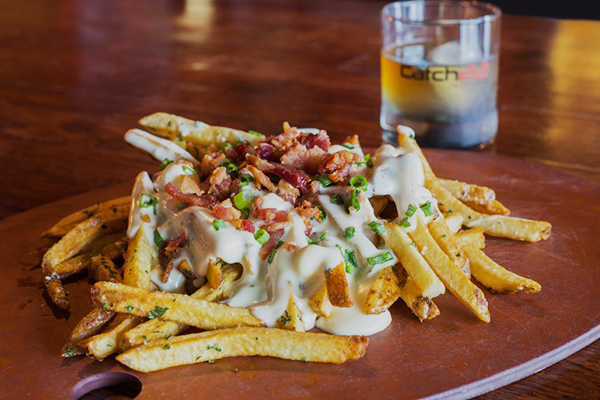 French fries on a plate topped with cheese sauce, bacon, and green onions | 1021 Parkway Blvd #117, Athens, GA 30606