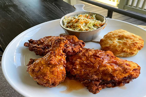 Plate of fried chicken with a biscuit and slaw in the background | 1073 S Milledge Ave, Athens, GA 30605