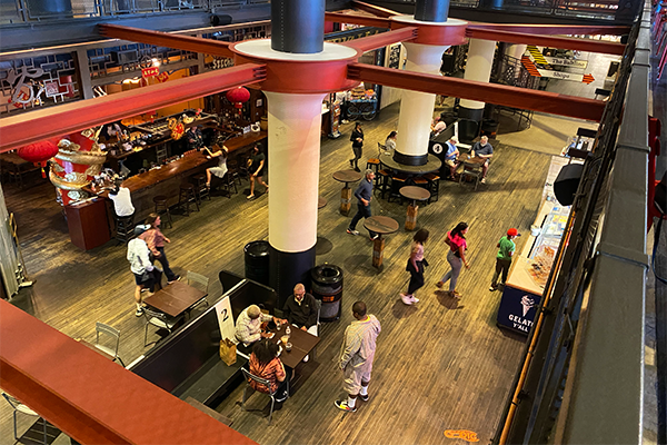 Overhead shot of food hall with customers ordering, sitting, and walking | 675 Ponce De Leon Ave NE, Atlanta, GA 30308
