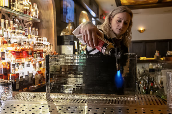 A bartender prepping ice at Red Phone Booth | Multiple Locations